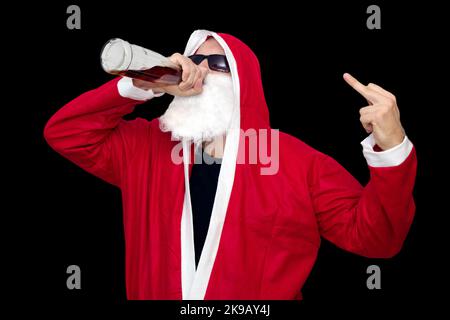 Bad Santa Claus with bottle of alcohol on black backround with middle finger up Stock Photo