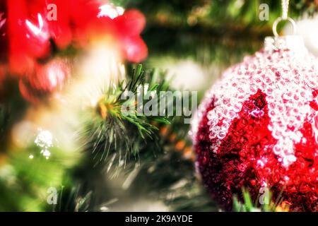 Detail of red christmas ball on a decorated Christmas tree. Stock Photo