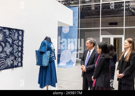 (221027) -- WAYNE, Oct. 27, 2022 (Xinhua) -- Huang Ping (1st L), the Chinese consul general in New York, views exhibits at an exhibition 'Textile Arts from Guizhou of China,' which is on view during an international symposium 'Across Time and Space: The Silk Road and the Silk City,' at the William Paterson University (WP) in Wayne, New Jersey, the United States, on Oct. 26, 2022. Known as U.S. 'Silk City,' Paterson, in the northeastern U.S. state of New Jersey, was considered to be the final stop for China's historic Silk Road that connected civilizations of different parts of the ancient worl Stock Photo