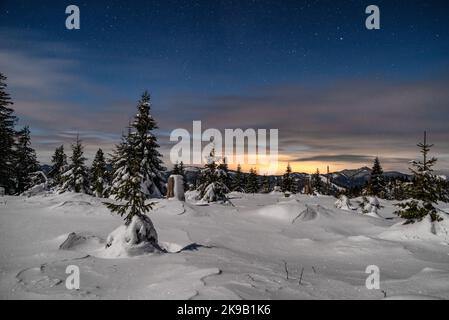 Winter mountain landscape. Snowy trees under sky at night in Smrekovica, Slovakia. Stock Photo