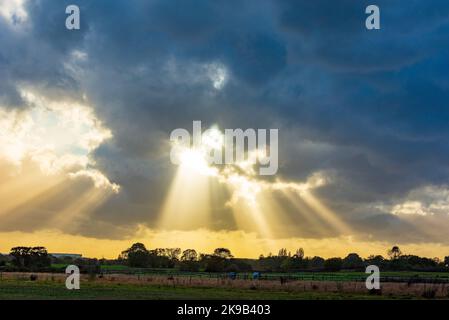 Dramatic skies with sun rays breaking through showing the end of the storm. Stock Photo