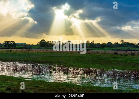 Dramatic skies with sun rays breaking through showing the end of the storm. Stock Photo