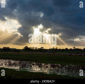 Dramatic skies with sun rays breaking through showing the end of the storm. Stock Photo