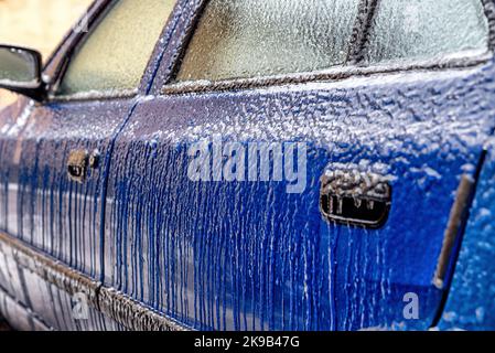 Crust of ice on car covered by icy rain. Stock Photo