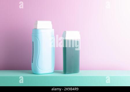 Hair removal equipment standing on green podium against purple background with blank space. Front view, beauty treatment, depilation concept. Stock Photo