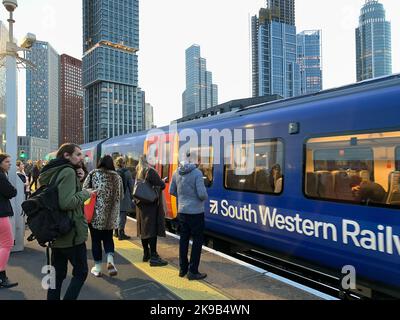 Vauxhall, London, UK. 27th October, 2022. Commuters waiting for a South Western Railway train at Vauxhall Railway Station. Further rail strikes are planned across some networks on 3rd, 5th, 7th and 9th November so passengers are being advised to avoid travelling on those dates if possible. Credit: Maureen McLean/Alamy Live News Stock Photo