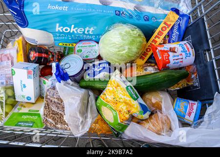 Berlin, Germany - October 27, 2022: View into a full shopping cart with various products for daily needs. Stock Photo