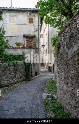 A typical street scene in old town Spoleto with traditional stone houses and narrow alleys photographed early morning. Umbria, Italy. Stock Photo