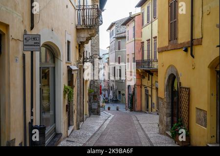 A typical street scene in old town Spoleto with traditional stone houses and narrow alleys photographed early morning. Umbria, Italy. Stock Photo