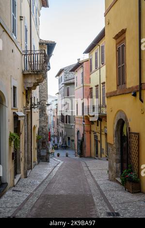 A typical street scene in old town Spoleto with traditional stone houses and narrow alleys photographed early morning. Umbria, Italy. Stock Photo