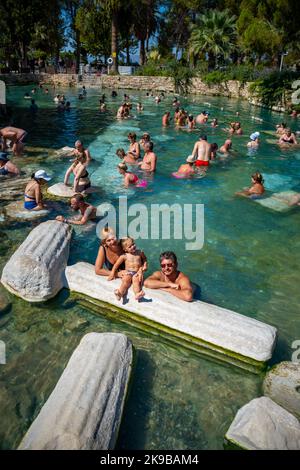 Pamukale, Turkey - September 14, 2022: Tourists enjoying the Antique pool Cleopatra's Bath in Pamukkale, Turkey Stock Photo
