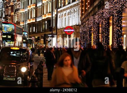 LONDON - DEC 3 : Christmas Lights Display, people present, on Brompton Road on Dec 3, 2013, London, UK. The modern colorful Christmas lights attract a Stock Photo