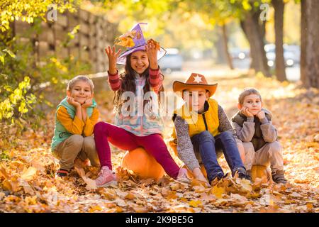 Kids picking and carving pumpkins at country farm Stock Photo