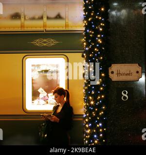 London, UK - December 3, 2013: Sign of Harrods Department, located in Brompton Road, with christmas decoration. Harrods, founder Charles Henry Harrod, Stock Photo