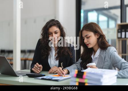 Diverse businesspeople cooperate work together discussing company financial statistics, multiracial colleagues collaborate brainstorm with finance on Stock Photo