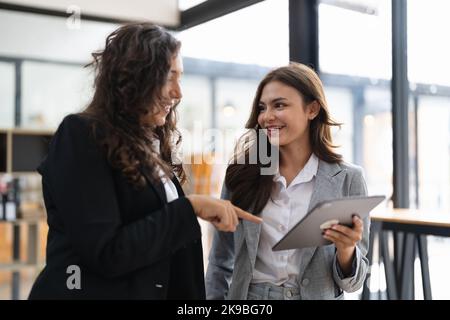 Diverse businesspeople cooperate work together discussing company financial statistics, multiracial colleagues collaborate brainstorm with finance on Stock Photo