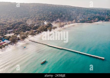 Mooring or towing bitts. Koh Rong island, Cambodia. Birds eye drone aerial view of single pier in crystal clear blue sea on secluded beach on Cambodia Stock Photo