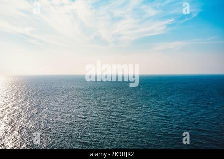 Seascape with sea horizon and almost clear deep blue sky - Background Stock Photo