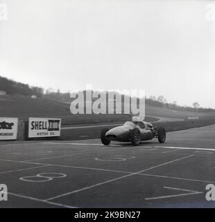 1959, historical, a Cooper motor racing car crossing the finishing line at the  Brands Hatch motor racing circuit, Kent, England, UK. At this time, the circcuit was home to the Cooper's Racing Driver's School. Stock Photo