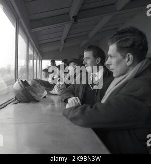 1959, historical, motor racing, Cooper Driving School, England, UK, instructors watching from an enclosed viewing gallery trackside, at Brands Hatch race circuit, Kent, England, UK. Stock Photo