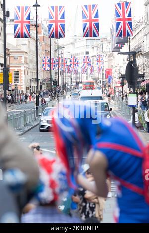 Revellers in Union Jack-themed costumes gather in Piccadilly Circus, central London, on the first day of the Platinum Jubilee weekend. Stock Photo