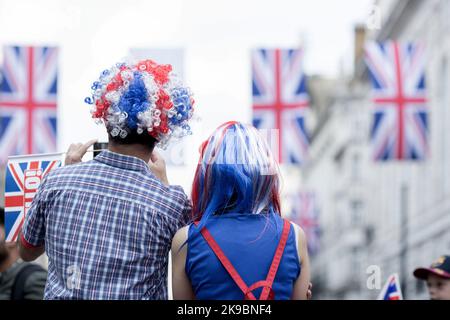 Revellers in Union Jack-themed costumes gather in Piccadilly Circus, central London, on the first day of the Platinum Jubilee weekend. Stock Photo