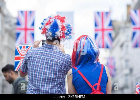 Revellers in Union Jack-themed costumes gather in Piccadilly Circus, central London, on the first day of the Platinum Jubilee weekend. Stock Photo