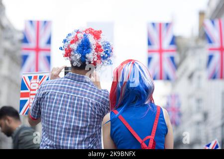 Revellers in Union Jack-themed costumes gather in Piccadilly Circus, central London, on the first day of the Platinum Jubilee weekend. Stock Photo