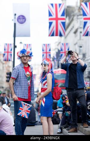 Revellers in Union Jack-themed costumes gather in Piccadilly Circus, central London, on the first day of the Platinum Jubilee weekend. Stock Photo