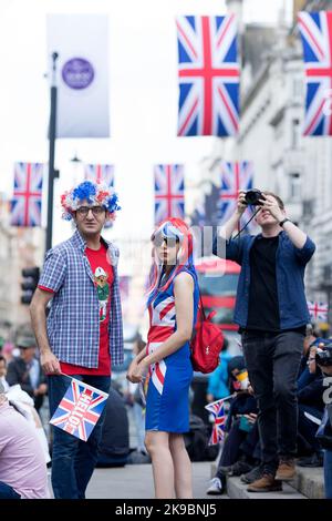 Revellers in Union Jack-themed costumes gather in Piccadilly Circus, central London, on the first day of the Platinum Jubilee weekend. Stock Photo