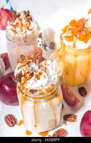 Apple, pumpkin and pecan pie smoothie drinks. Traditional autumn baking cake flavor cocktails set, on white background copy space Stock Photo