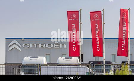 Belgrade, Serbia - August 19, 2022: Red Flags at French Car Citroen Dealership and Service Garage at Highway. Stock Photo