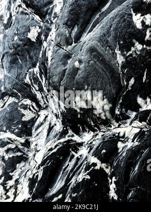 Full frame texture background of hard granite rock with calcium deposits creating marble effect with copy space Stock Photo