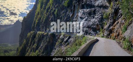 Male road cyclist riding up the balcony road from Bourg d'Oisans to Villard Notre Dame, French Alps. Stock Photo