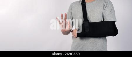 Broken arm. Arm Sling therapy support and covered around elbow first knuckle broken arm. Post Operative Care. Fractures of humerus radius ulna scapula Stock Photo