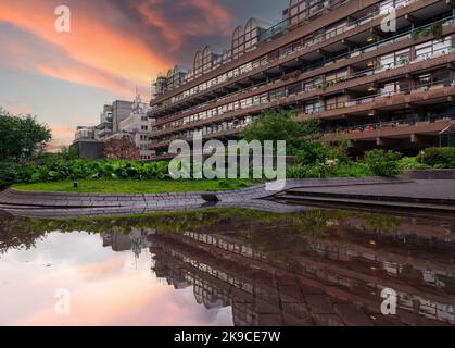 London, England, UK - October 22, 2022: The Barbican Centre in London city. View of the iconic Brutalism architecture of the Barbican Estate illuminat Stock Photo