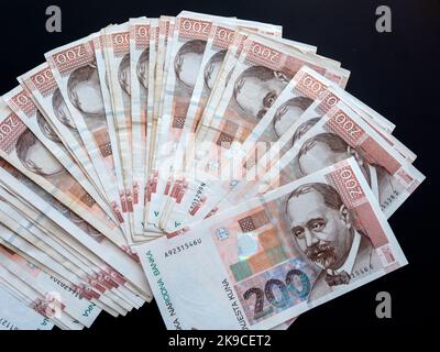 Piled together many lined Croatian Croatia Kuna Kune Kunas banknotes Black background Stock Photo