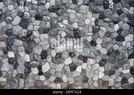 Dry Stacked cut stone wall texture. Natural rocks fence Stock Photo