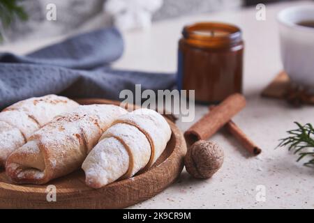 Classic aesthetic Christmas crescent handmade bagels with cinnamon sticks and walnuts. Cozy home. Stock Photo