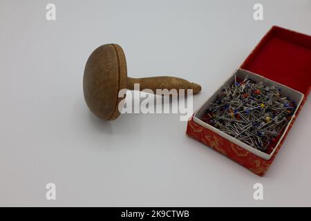 A darning mushroom, a needle and thread on a wooden surface Stock Photo -  Alamy