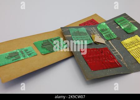 Sewing accessories on a white background. Sewing needles in paper holders. Stock Photo