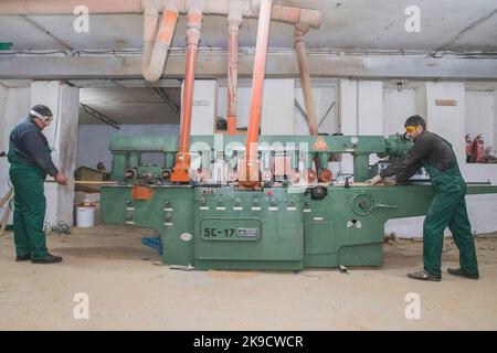 Skvira, Ukraine, March 2018: workers passes boards through a jointer Stock Photo