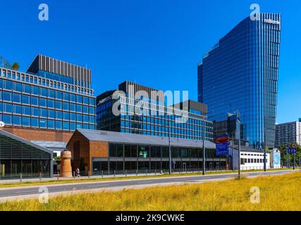 Warsaw, Poland - July 3, 2022: Fabryka Norblina office and retail redevelopment complex by ArtN and Capital Park with Mennica Legacy Tower Stock Photo