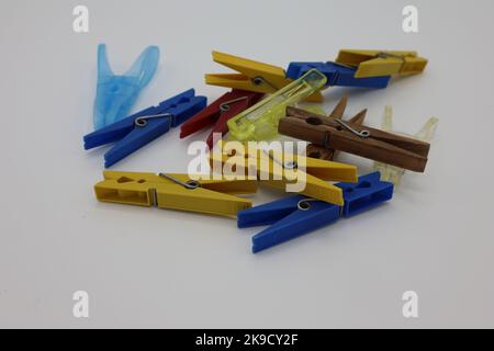 Colorful clothespins or clothes pegs laying on a white background Stock Photo