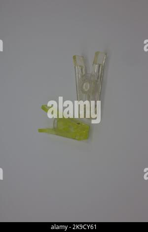 Colorful clothespins or clothes pegs laying on a white background Stock Photo