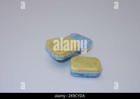 Dishwasher tabs or tablets in a water soluble transparent film packaging on a white background Stock Photo