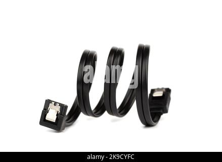 Soft focus on a black cable with a SATA connectors on a white background. Focus on the front SATA connector. Copy space. Stock Photo