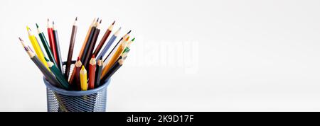 Colored pencils bunch in metal holder, office basket on ad background, creative banner. High quality photo Stock Photo