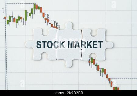 Business concept. On the quotes chart there are puzzles with the inscription - STOCK MARKET Stock Photo