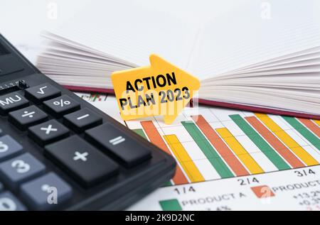 Business concept. On the business charts there is a notepad, a pen and an arrow sticker with the inscription - Action Plan 2023 Stock Photo